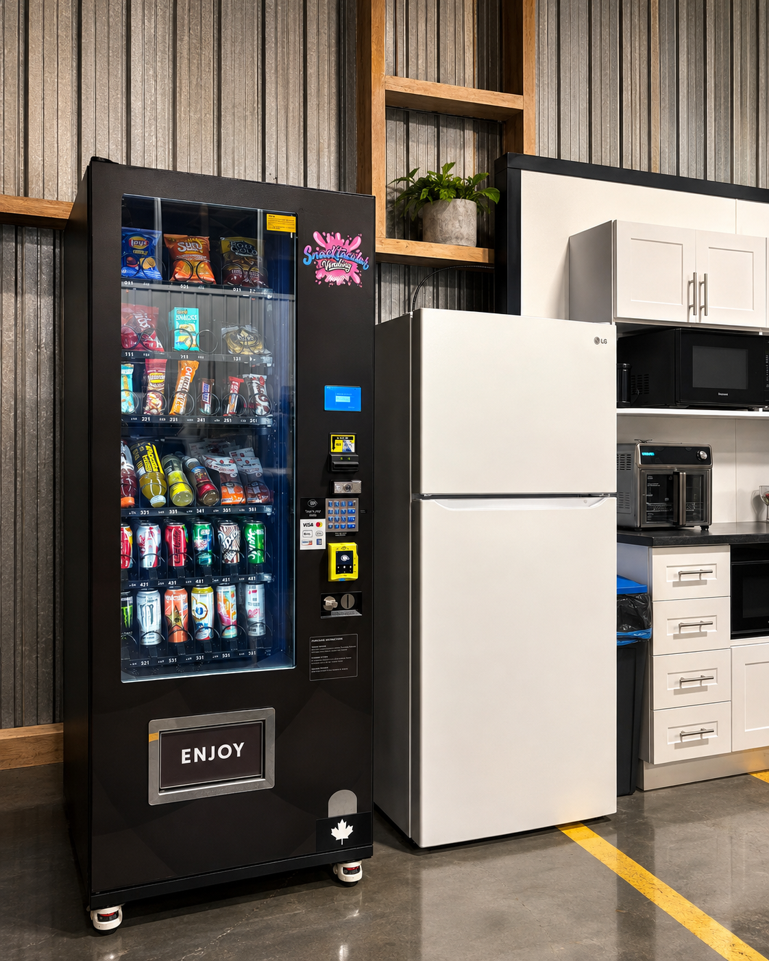 A Snacktacular vending machine against the wall in a bright modern office, with a pink splash accent