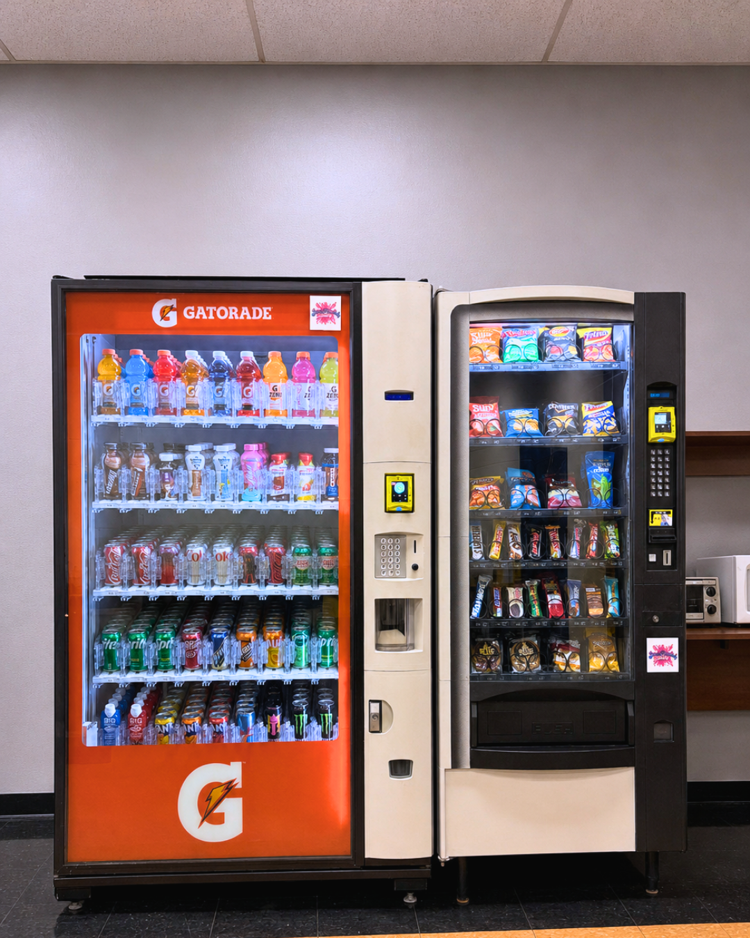 A woman enjoying a snack from a Snacktacular machine in a clinic, a little joy in the day